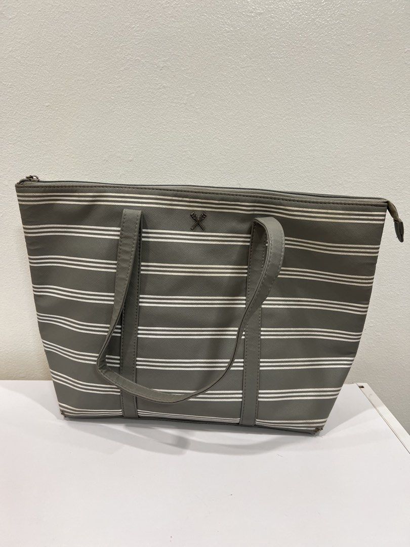 Regatta gray and white stripe tote bag (Category: Tote Bags) located in Manila. Submitted by threadtressure (Listing ID 1454910763, Image 1). Description: Regatta gray and white stripes tote bag. Zippers all functioning well Condition: 6/10 Issues: Peeling on the sides of the bag (see photos).