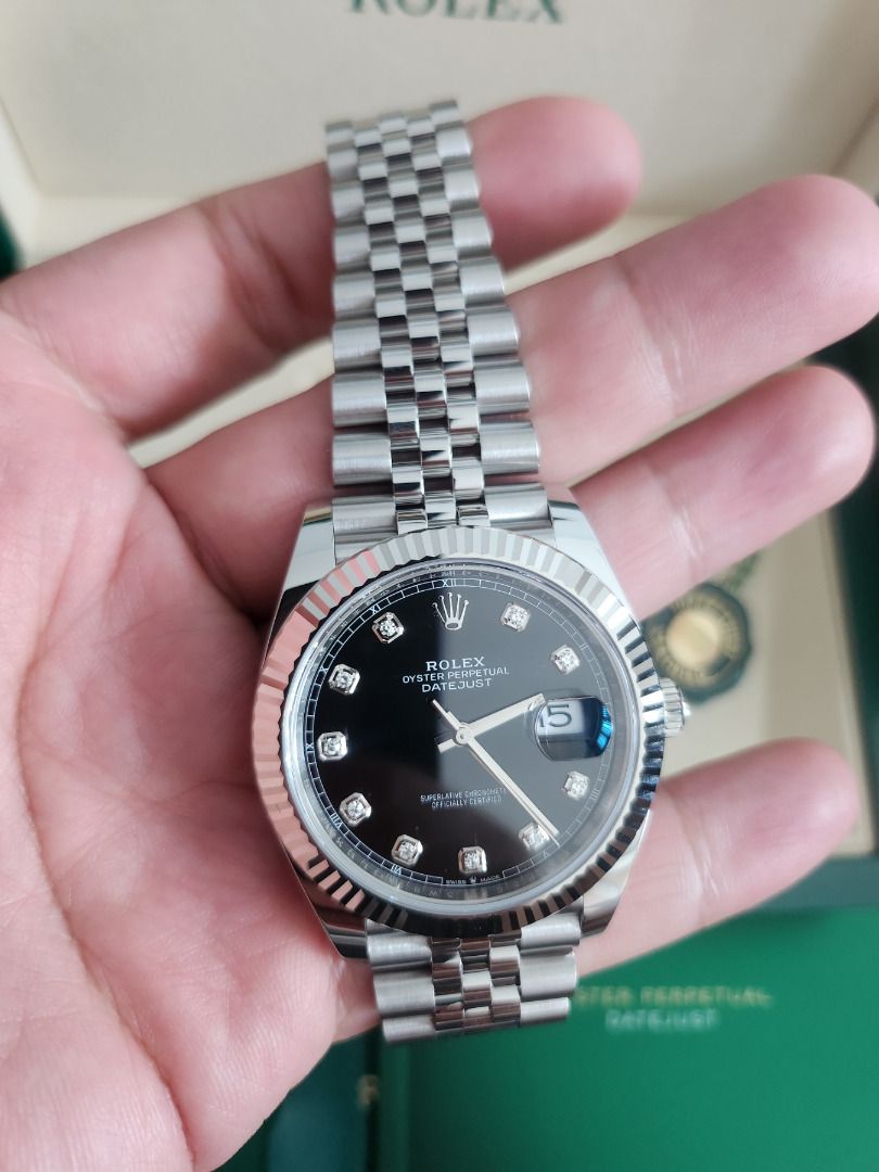 Rolex Datejust 41 – Black Dial with Diamonds (Category: Luxury Watches) located in Taguig. Submitted by fairmarkco (Listing ID 1454752823, Image 2). Description: Don't settle with a second hand watch. Crown your achievement. ⌚ FOR SALE: Rolex Datejust 41 – Black Dial with Diamonds ✨ 📍 Available in Metro Manila 💼 Model: Rolex Datejust 41 🖤 Dial: Black with Factory Diamond Hour Markers 🔗 Bracelet: Jubilee Bracelet 💎 Bezel: Fluted 📦 Set: [Box,