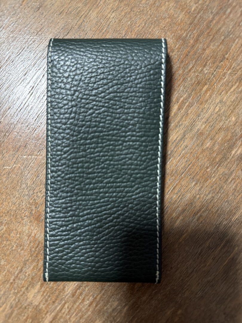 Rolex Pouch (Category: Accessories) located in Singapore. Submitted by belgiumgollie (Listing ID 1454893639, Image 2). Description: - Genuine Rolex pouch - Color: Deep forest green - Material: Textured leather - Design: Classic flap with embossed Rolex crown - Features: White contrast stitching, secure snap closure - Condition: Excellent, brand new - Ideal for storing and protecting your Rolex watch.