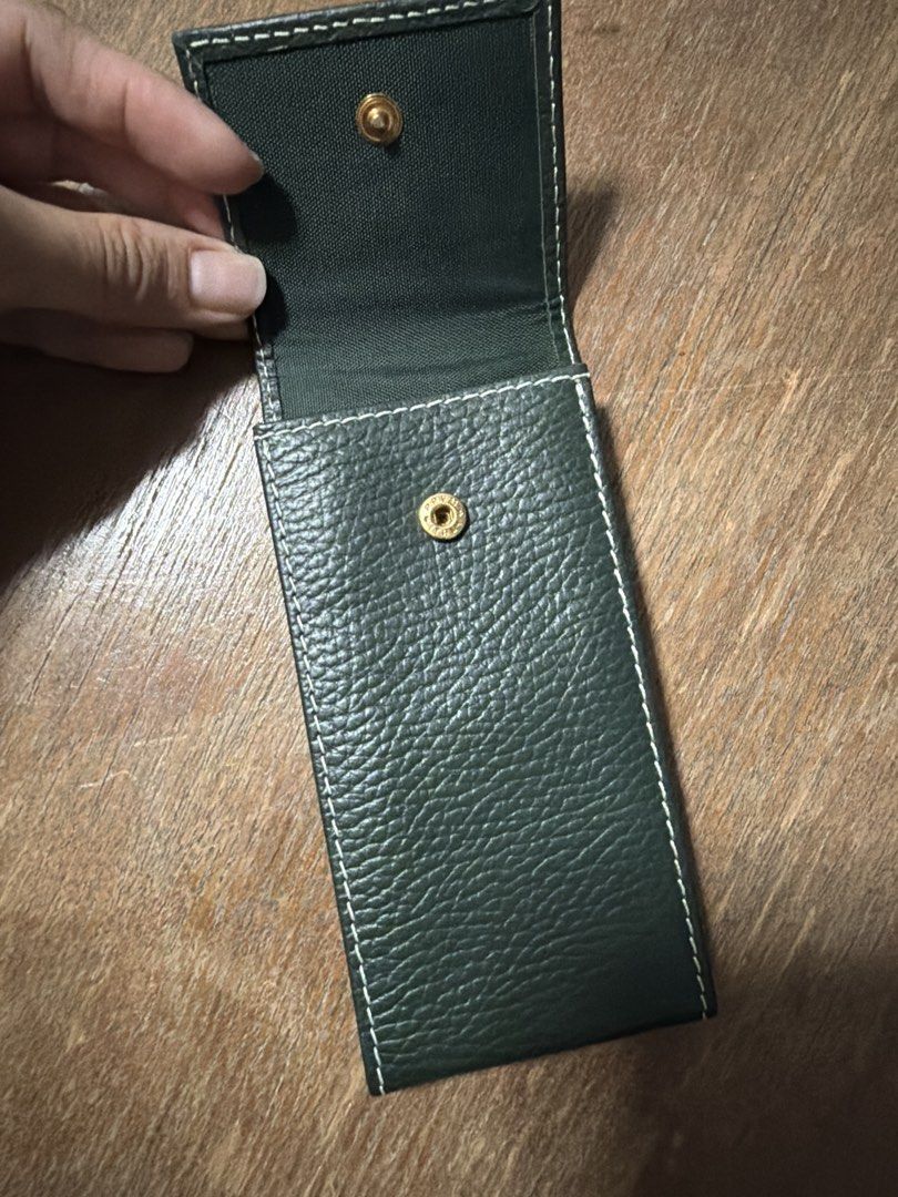 Rolex Pouch (Category: Accessories) located in Singapore. Submitted by belgiumgollie (Listing ID 1454893639, Image 3). Description: - Genuine Rolex pouch - Color: Deep forest green - Material: Textured leather - Design: Classic flap with embossed Rolex crown - Features: White contrast stitching, secure snap closure - Condition: Excellent, brand new - Ideal for storing and protecting your Rolex watch.