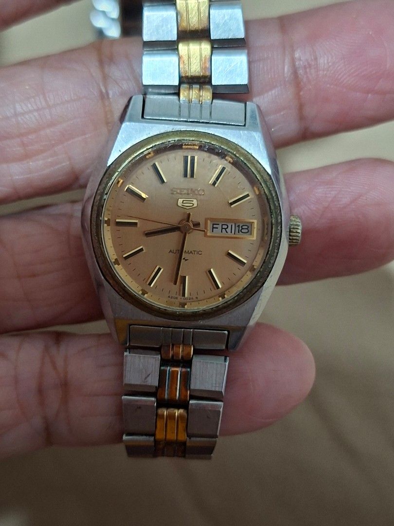 Seiko 5 Automatic Two-Tone Watch (Category: Women's Watches) located in Bulacan. Submitted by rafaesarisari (Listing ID 1454876529, Image 1). Description: - Vintage Seiko 5 Automatic Watch - Champagne Dial - Day and Date Window at 3 o'clock - Two-Tone Stainless Steel and Gold-Tone Bracelet - Signs of wear consistent with age (case and bracelet) - Classic and timeless timepiece.