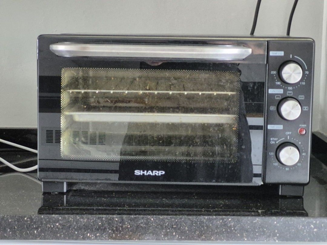 Sharp Oven (Category: Ovens & Toasters) located in Singapore. Submitted by usaoutlets (Listing ID 1454823964, Image 1). Description: - Sharp oven in good working condition. - Comes with multiple racks for versatile cooking. - Features adjustable temperature controls. - Full-door opening for easy loading and unloading. - Minor signs of use inside, as pictured..