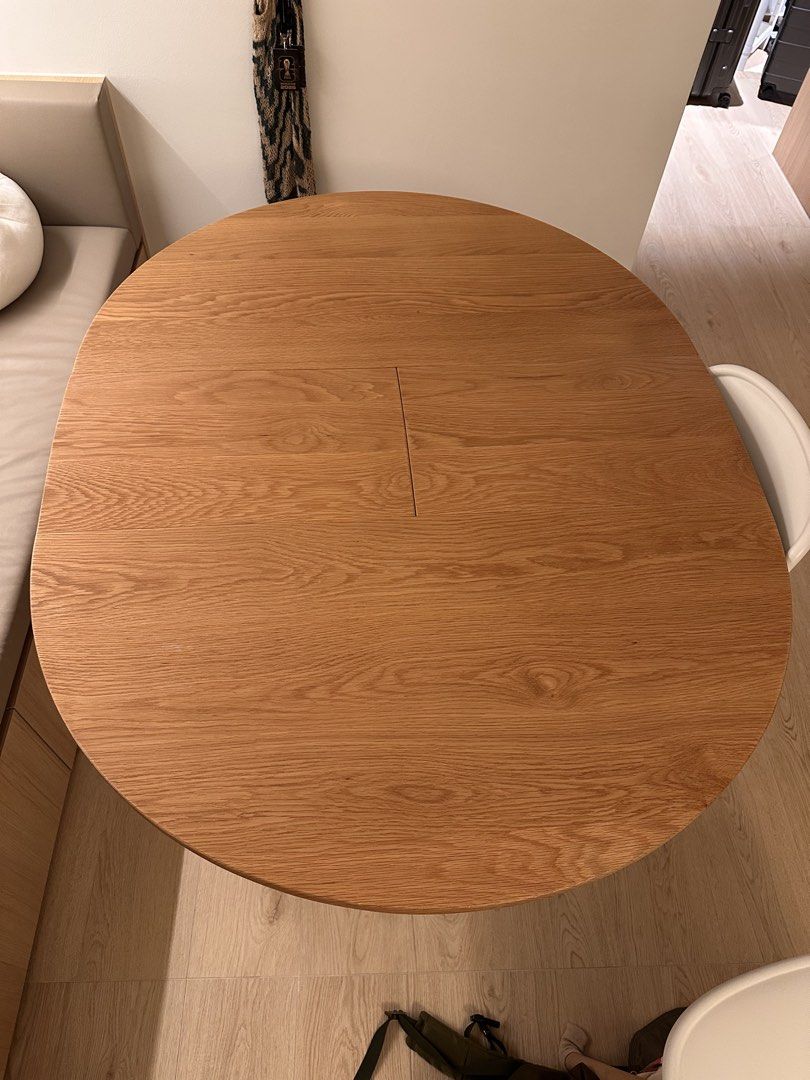 Solid wood dining table (Category: Tables & Sets) located in Singapore. Submitted by supiyamy (Listing ID 1454808512, Image 1). Description: Solid wood table, slightly warped as can be seen in the photo. Think of it like a wavy (?) table top! It is expandable. Dimensions - Before expanding: 100x100cm - After expanding: 100x130cm It still works find as a table just not flat! Looking to quickly sell by first week September. Moving and dismantling n
