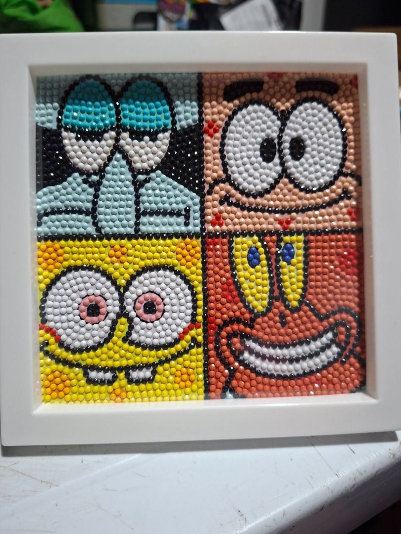 SpongeBob SquarePants Diamond Painting Art Frame (Category: Art & Prints) located in Tagaytay City. Submitted by maestraklarissa (Listing ID 1454889108, Image 1). Description: - Handmade diamond painting art featuring SpongeBob, Patrick, Squidward, and Mr Crabs. - Square frame design. - Perfect for fans of the SpongeBob SquarePants show. - Adds a vibrant pop of color to any room. - Crafted with small, detailed beads..