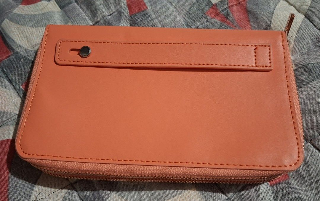 Starbucks Orange Zip Around Wallet (Category: Wallets & Card holders) located in Muntinlupa City. Submitted by abunching (Listing ID 1454867833, Image 2). Description: - Orange Starbucks wallet - Zip-around closure for security - Multiple card slots inside for organization - Rose gold zipper pulls with Starbucks logo - Compact and convenient for everyday use.