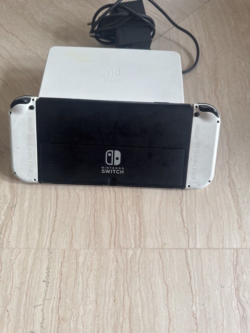 Switch Oled Set (Category: Nintendo) located in Singapore. Submitted by gingyassault (Listing ID 1454753306, Image 3). Description: 1x Switch Oled 1x Controller with case 2x joycons (read desc) 1x dock 1x power adapter 1x Dragon quest builders 2 game As you can see in the pictures, the joycons and the dock aren’t in pristine condition. joycons work with no drift, though you can see the right one the right joycon is a little loose. I will include 