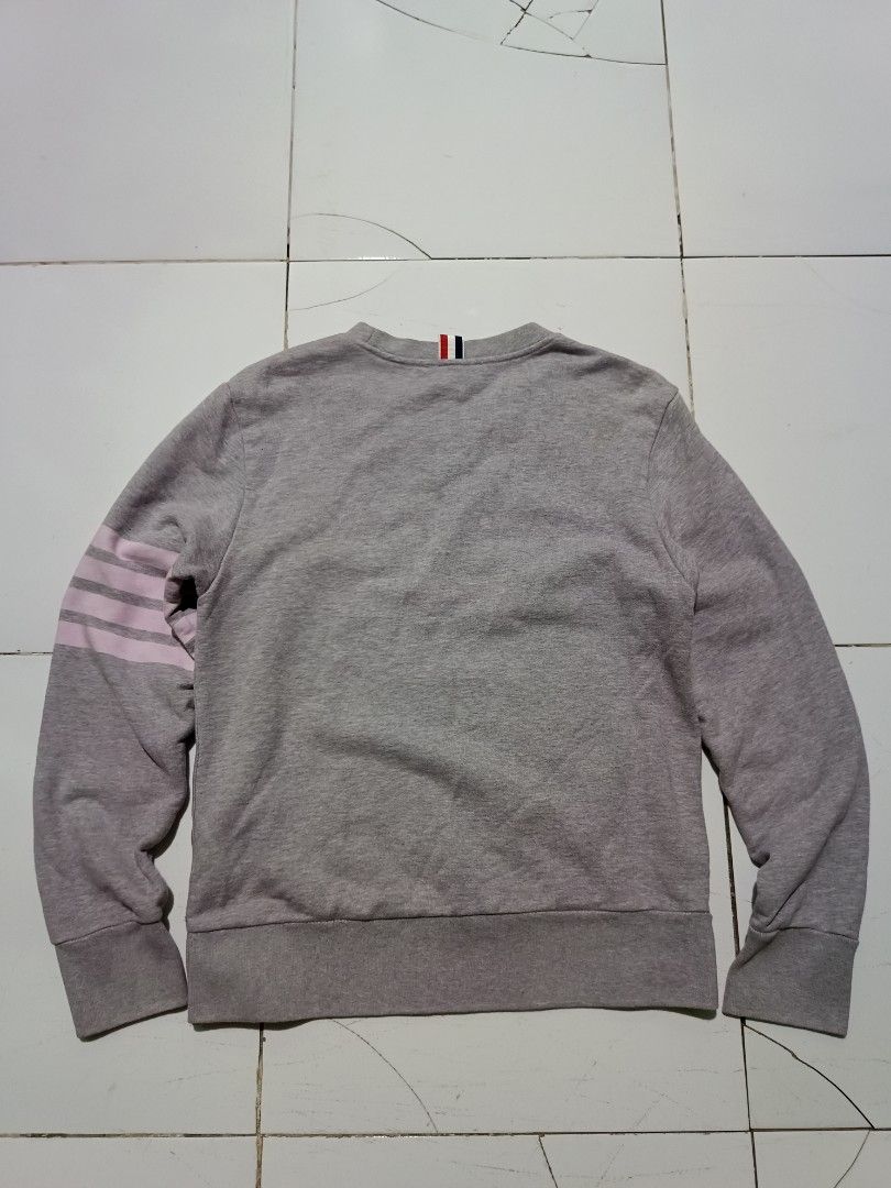 Thom Browne Grey Sweatshirt Pink Stripes Size 1 (Category: Luxury Apparel) located in Barotac Nuevo. Submitted by gray101 (Listing ID 1454877855, Image 2). Description: - Authentic Thom Browne grey sweatshirt - Size: 1 - Signature pink stripes on the left sleeve - Button details on the side hem - Made in Japan.