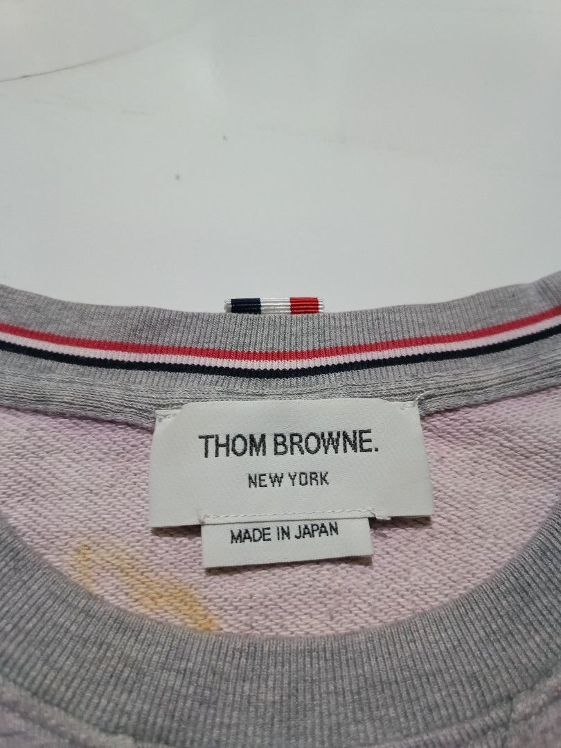 Thom Browne Grey Sweatshirt Pink Stripes Size 1 (Category: Luxury Apparel) located in Barotac Nuevo. Submitted by gray101 (Listing ID 1454877855, Image 3). Description: - Authentic Thom Browne grey sweatshirt - Size: 1 - Signature pink stripes on the left sleeve - Button details on the side hem - Made in Japan.