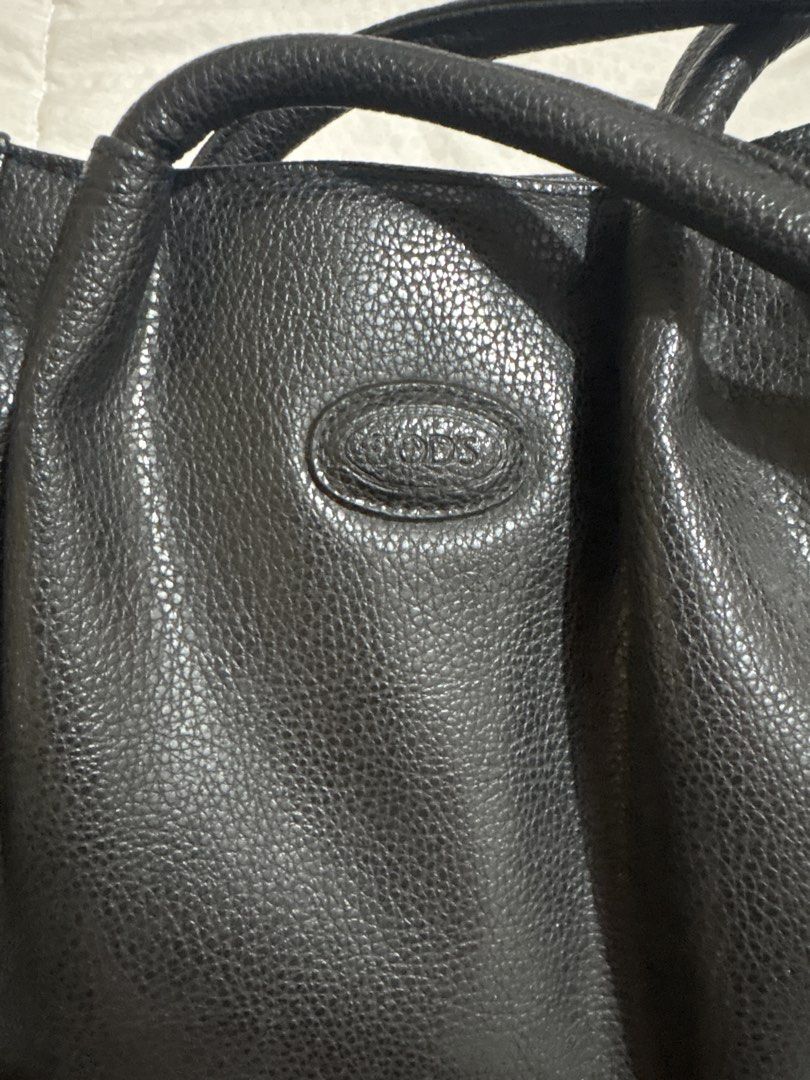Tod's Black Leather Tote Bag (Category: Luxury Bags & Wallets) located in Manila. Submitted by nykji96 (Listing ID 1454813121, Image 1). Description: - Classic black leather tote from Tod's - Pebbled leather texture - Top handles for comfortable carrying - Spacious interior, ideal for daily essentials - Timeless design that complements any outfit - Authenticity guaranteed.