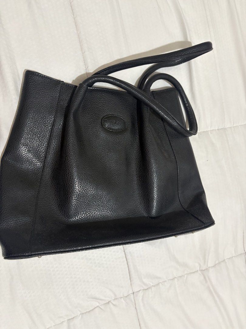 Tod's Black Leather Tote Bag (Category: Luxury Bags & Wallets) located in Manila. Submitted by nykji96 (Listing ID 1454813121, Image 2). Description: - Classic black leather tote from Tod's - Pebbled leather texture - Top handles for comfortable carrying - Spacious interior, ideal for daily essentials - Timeless design that complements any outfit - Authenticity guaranteed.