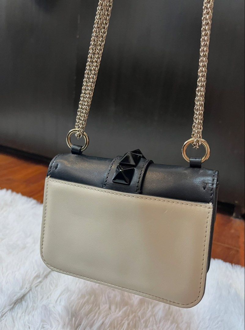 Valentino Rockstud Shoulder Bag Black Cream (Category: Luxury Bags & Wallets) located in Manila. Submitted by fasttree-3c0a1d (Listing ID 1454900872, Image 3). Description: - Authentic Valentino shoulder bag - Color: Black and Cream - Signature Rockstud detailing - Gold chain strap - Secure turn-lock closure - Small size, perfect for essentials.