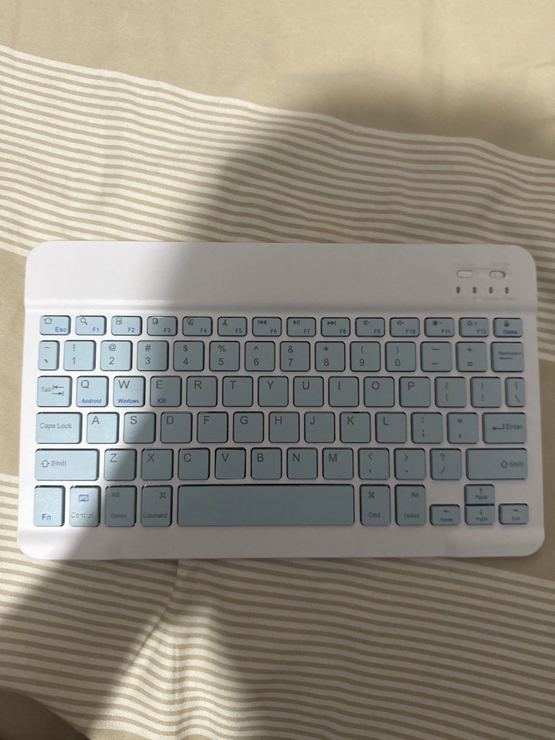White Bluetooth Keyboard with Blue Keys (Category: Computer Keyboard) located in Manila. Submitted by fiercedog-92315c (Listing ID 1454935563, Image 1). Description: Ipad keyboard magnetic 9thgen series Didn’t use - Slim and portable white Bluetooth keyboard - Light blue keys with a sleek silver back panel - Wireless connectivity - Compatible with Android, iOS, and Windows devices - Ideal for on-the-go typing or desk use - Tested and confirmed wo