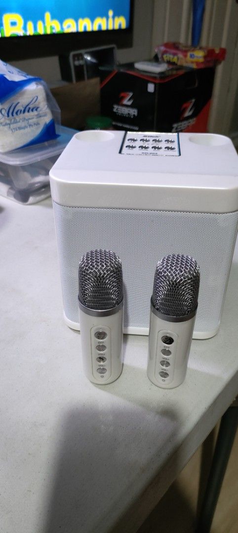 White Karaoke Speaker with 2 Microphones (Category: Soundbars, Speakers & Amplifiers) located in Quezon City. Submitted by nobody241625 (Listing ID 1454930425, Image 2). Description: - Portable white karaoke speaker - Includes 2 wireless microphones - Ideal for parties and singing sessions - Easy to set up and use - Take your karaoke anywhere - Speaker features a mesh fabric front -fishermall qc meet up - Microphones are silver and white.