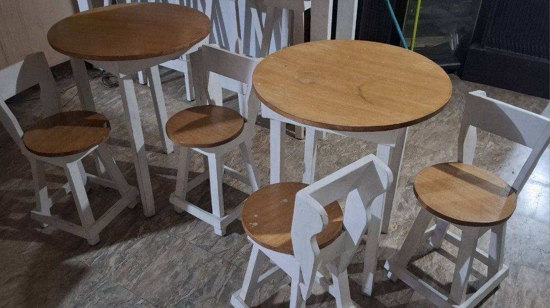 Wooden Bar Table with 4 White Stools and Storage Bench (Category: Tables & Sets) located in Manila. Submitted by yuichi0418 (Listing ID 1454903426, Image 2). Description: - Includes 1 bar table (wooden top, white base) - Includes 4 bar stools (white with wooden seats) -includes 2 round tables with 4chairs - Includes 2 storage bench (white, wooden top) - Ideal for home bar or cafe settings - Minor scuffs on white paint due to normal use Take all f