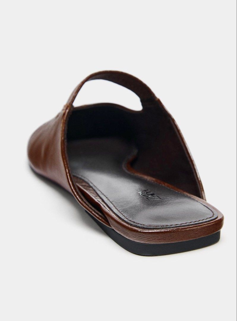 Zara flat mule ballet sandals (Category: Slippers and slides) located in Pasig City. Submitted by redeem (Listing ID 1454897334, Image 3). Description: AVAILABLE ON HAND‼️ Brand new with tag‼️ With Dust Bag‼️ Size: Euro 38 Description: Flat mule ballet shoes . Topstitching detail on the front. Elastic strap on the instep. Round toe. Color: BROWN.