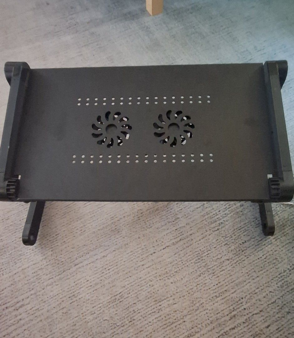 Adjustable Laptop Stand with Cooling Fans (Category: Laptop Bags & Sleeves) located in Caloocan City. Submitted by rabeela (Listing ID 1455094486, Image 1). Description: - Portable laptop stand with built-in cooling fans - Keeps your laptop cool during extended use - Adjustable legs for customizable height and angle - Durable black metal construction - Easy to set up and use anywhere - Perfect for home or office environments.