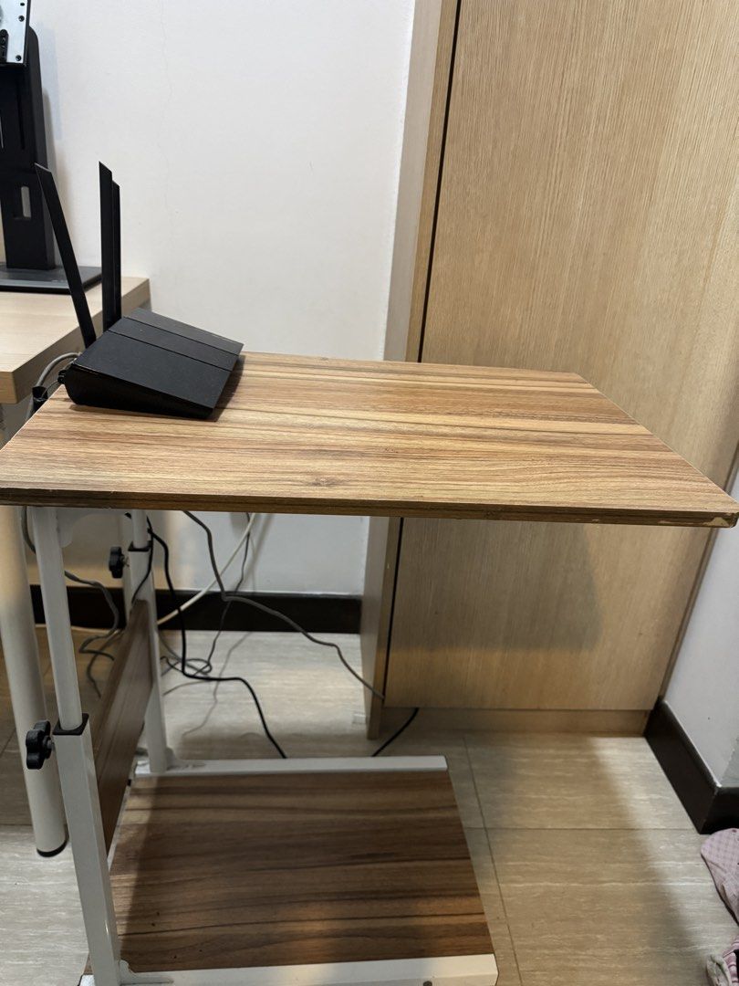 Adjustable Side Table (Category: Tables & Sets) located in Singapore. Submitted by ilyd. (Listing ID 1455109099, Image 2). Description: - Convenient side table - Adjustable height - Built-in shelf underneath for extra storage. - Equipped with wheels for easy mobility. - Ideal for laptops, or as a bedside table. - Collect by 22 August.