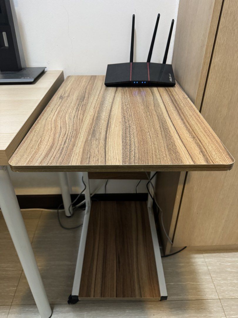 Adjustable Side Table (Category: Tables & Sets) located in Singapore. Submitted by ilyd. (Listing ID 1455109099, Image 1). Description: - Convenient side table - Adjustable height - Built-in shelf underneath for extra storage. - Equipped with wheels for easy mobility. - Ideal for laptops, or as a bedside table. - Collect by 22 August.