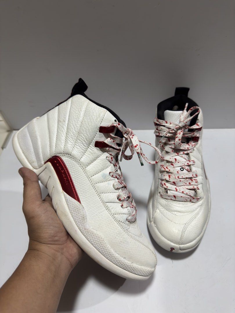 Air Jordan 12 Retro White Red Splatter (Category: Sneakers) located in Manila. Submitted by mislangers_stuff (Listing ID 1455139384, Image 2). Description: - Classic White and Red Air Jordan 12s - Features iconic Jordan 23 logo on the heel - Comes with unique splatter laces - A must-have for any serious Jordan collector.