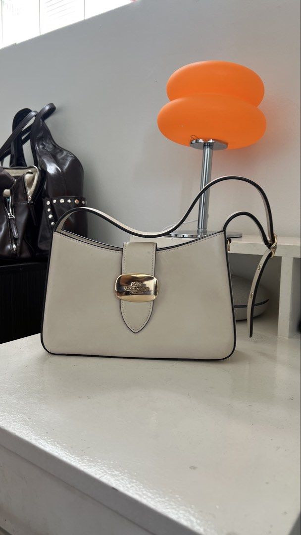 Authentic Coach Eliza Shoulder Bag (Category: Luxury Bags & Wallets) located in Quezon City. Submitted by sr_1521 (Listing ID 1454969824, Image 2). Description: Bought in New Orleans USA 2024 Barely used but has signed of usage (minor scratches, dirt marks, scratch on buckle) Needs light cleaning Kindly manage expectations as this is a used item 🙏🏻.