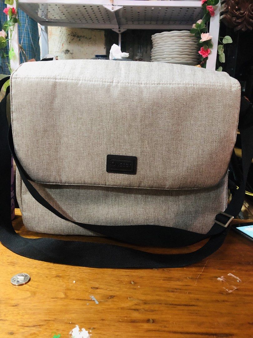 Baby Style Diaper Bag Messenger Bag (Category: Diaper Bags & Wetbags) located in Manila. Submitted by noemiaspa1702 (Listing ID 1455102753, Image 1). Description: - Grey herringbone diaper bag - Flap closure with black strap - Includes a changing mat - Features a shoulder strap for easy carrying - Plenty of space inside - Ideal for parents on the go.