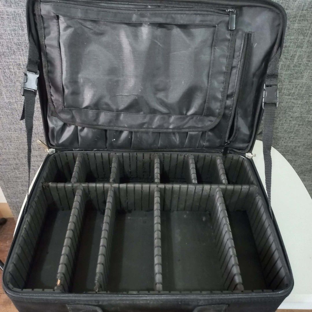 Black Makeup Train Case with Compartments and Straps (Category: Makeup) located in Quezon City. Submitted by lui_gonzales (Listing ID 1455021114, Image 1). Description: - Stylish black makeup train case - Two-tier storage for excellent organization - Top tier: Elastic pockets and zippered mesh compartment - Bottom tier: Adjustable dividers for customizable storage - Secure zipper closure - Convenient front handle for easy carrying - Detachable sh