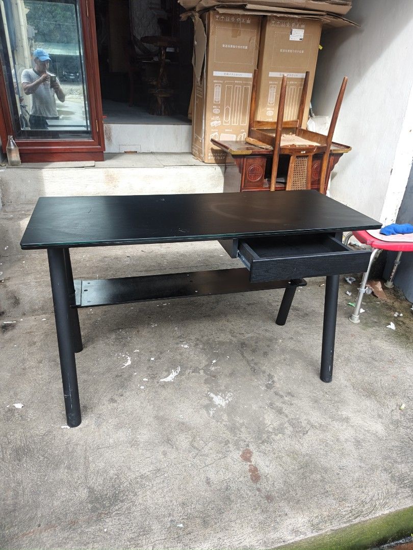 Black Study Desk with Drawer and Shelf (Category: Tables & Sets) located in Valenzuela. Submitted by kendra071914 (Listing ID 1455105330, Image 2). Description: - Sleek black study desk - Built-in drawer for essentials - Lower shelf for extra storage - Durable glass overlay on tabletop - Dimensions: Height 73cm, Length 120cm, Width 50cm - Ideal for home office or study area - Simple and functional design.