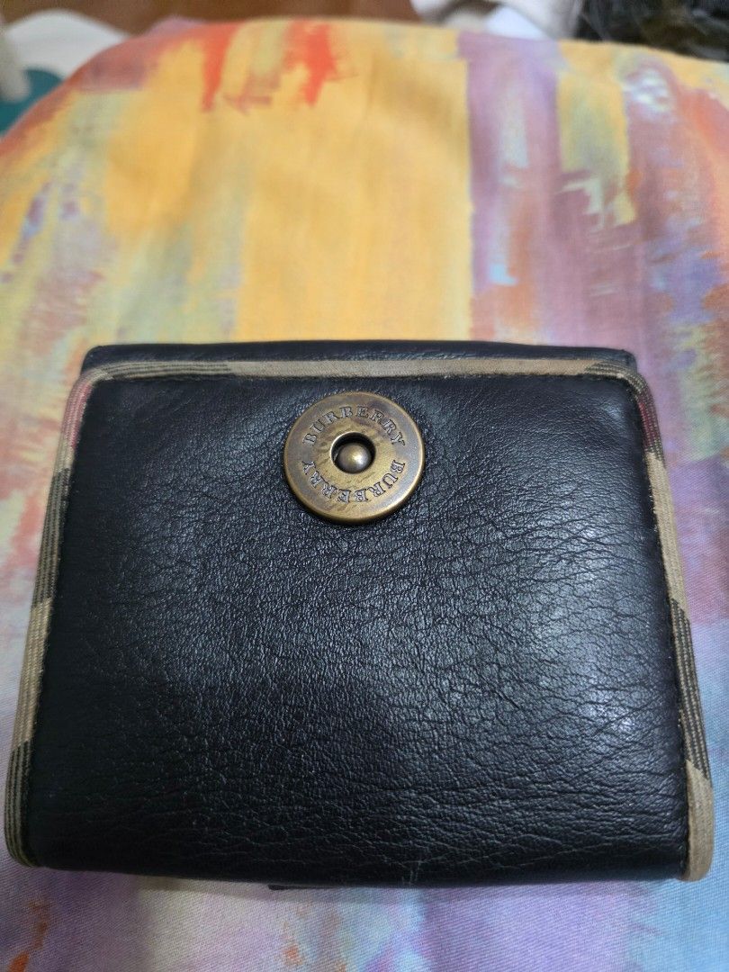 Burberry Black Leather Bifold Wallet (Category: Luxury Bags & Wallets) located in Manila. Submitted by ciachayger03544 (Listing ID 1454952755, Image 1). Description: - Authentic Burberry bifold wallet - Color: Black leather - Interior: Classic Burberry check lining - Closure: Main compartment snap closure, separate coin pouch with snap closure - Features: Multiple card slots and bill compartments - Condition: Shows some signs of wear consistent w