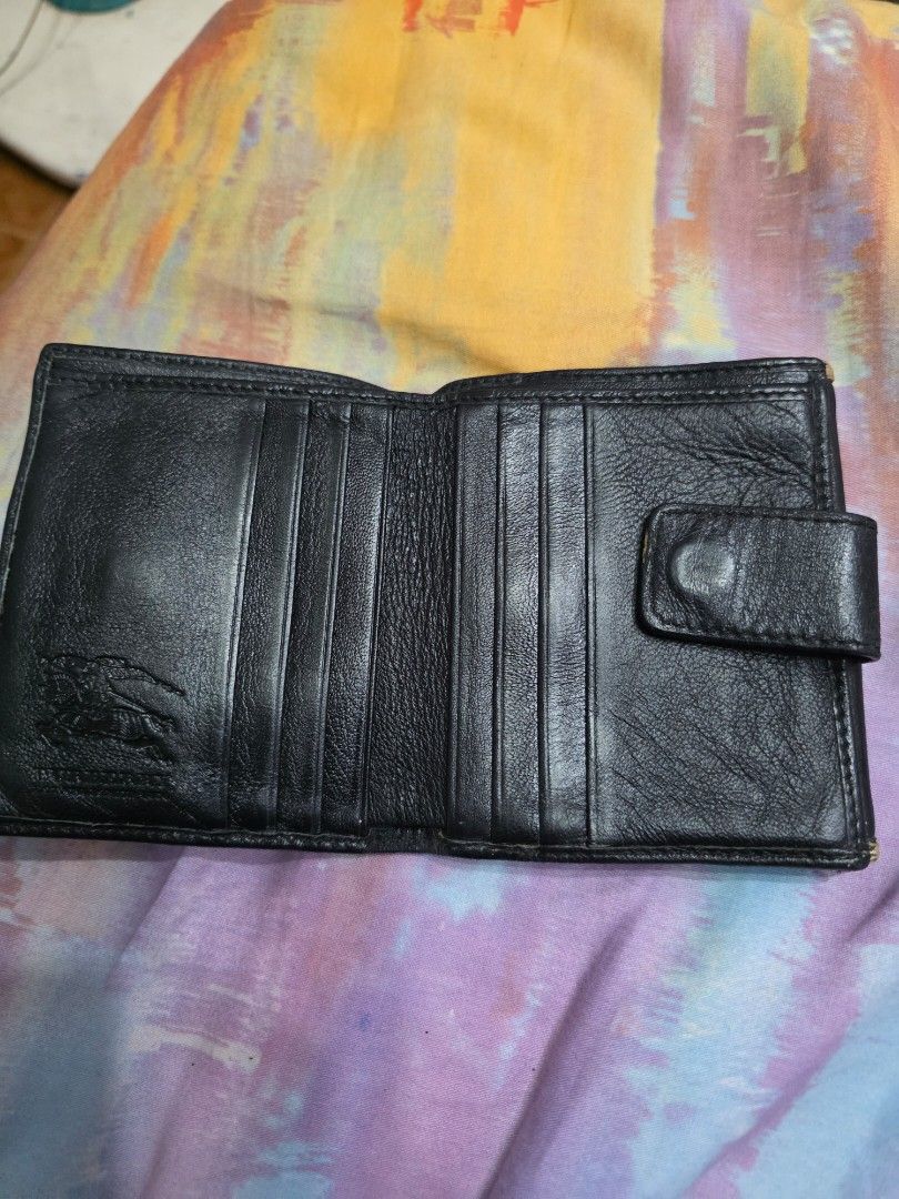 Burberry Black Leather Bifold Wallet (Category: Luxury Bags & Wallets) located in Manila. Submitted by ciachayger03544 (Listing ID 1454952755, Image 3). Description: - Authentic Burberry bifold wallet - Color: Black leather - Interior: Classic Burberry check lining - Closure: Main compartment snap closure, separate coin pouch with snap closure - Features: Multiple card slots and bill compartments - Condition: Shows some signs of wear consistent w