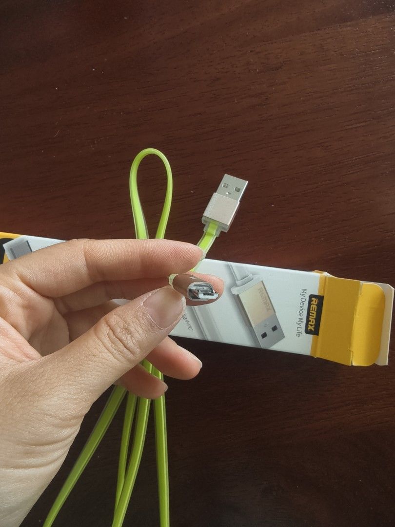Cable wire (Category: Chargers & Cables) located in Singapore. Submitted by gorbi2021 (Listing ID 1454984772, Image 1). Description: - Brand: Remax - Color: Lime Green - Type: Charging Cable - Condition: Good - Meetup locations: Raffles Place MRT, Lorong Chuan MRT.