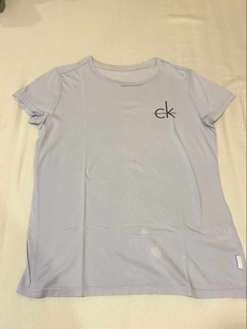 Calvin Klein Light Blue T-Shirt (Category: Shirts) located in Quezon City. Submitted by m4delineee (Listing ID 1455127171, Image 1). Description: - size: S - CK powder blue tee, soft thin cotton fabric - has minor stains on the bottom.