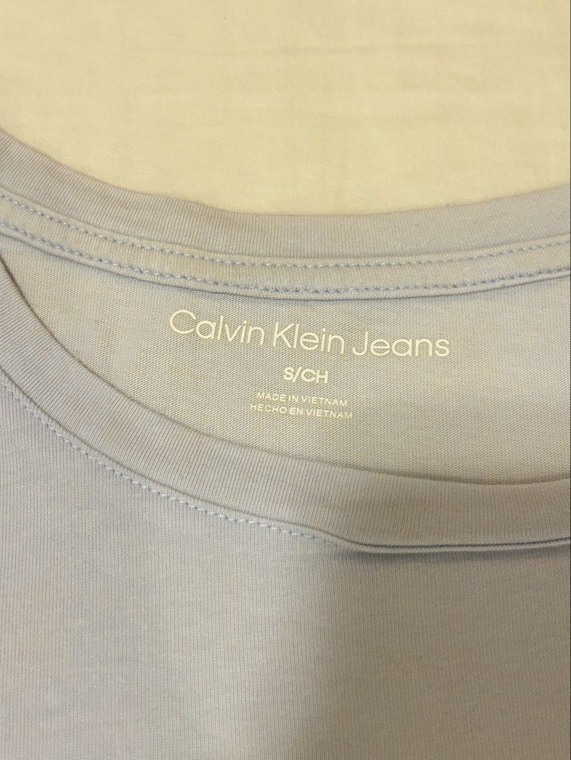 Calvin Klein Light Blue T-Shirt (Category: Shirts) located in Quezon City. Submitted by m4delineee (Listing ID 1455127171, Image 2). Description: - size: S - CK powder blue tee, soft thin cotton fabric - has minor stains on the bottom.