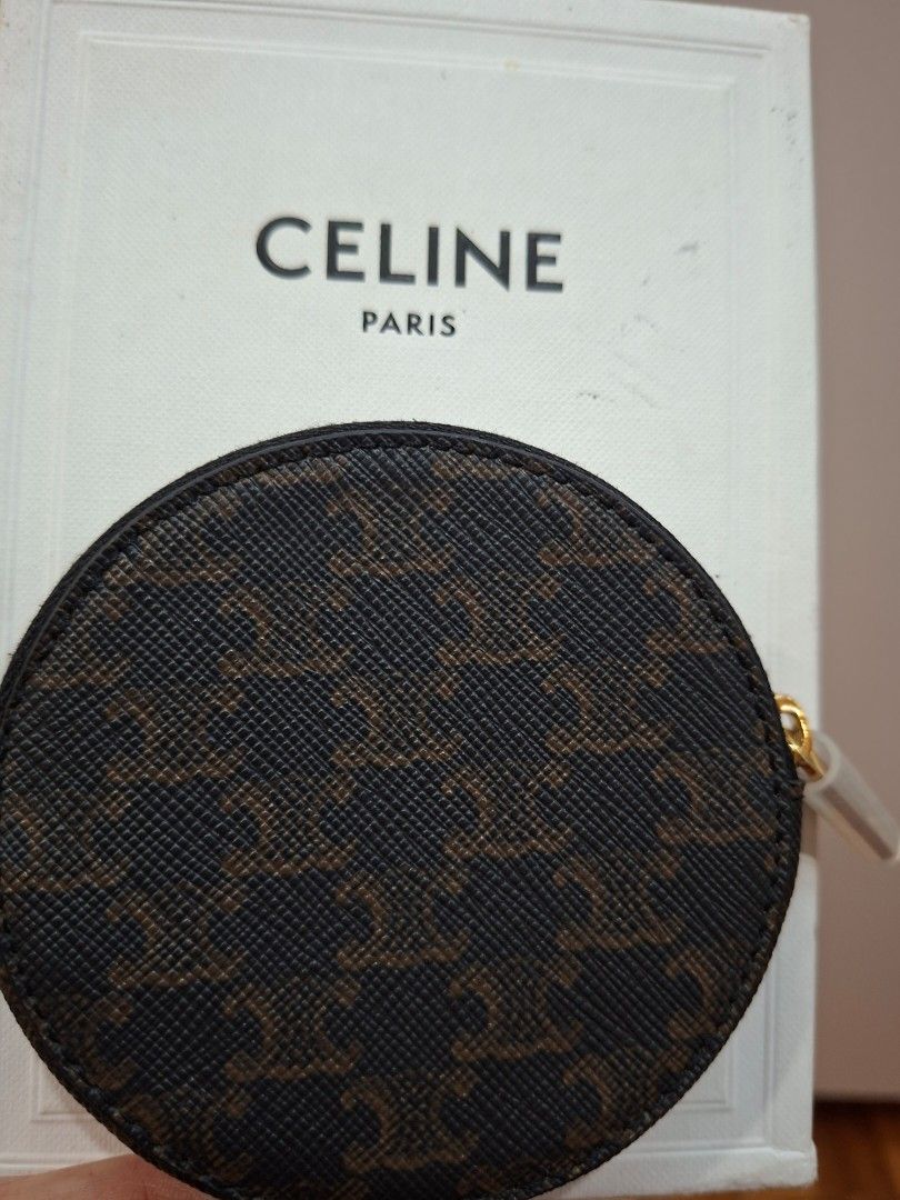 KEPT UNUSED Triomphe Canvas Round Coin Pouch with zipper (Category: Luxury Bags & Wallets) located in Mandaluyong City. Submitted by k__z__ (Listing ID 1454958167, Image 3). Description: - Authentic Celine coin pouch - Signature Triomphe canvas with monogram pattern - Includes original box and dust bag - Secure zipper closure (zipper still with intact cover) -smooth leather interior - Perfect for organizing small essentials.