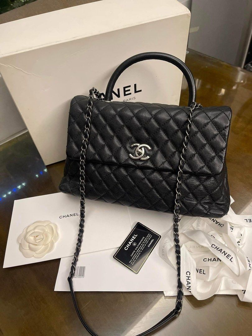 Chanel Black Caviar Coco Handle Bag (Category: Luxury Bags & Wallets) located in Davao. Submitted by makeupbynoeh (Listing ID 1455118314, Image 1). Description: - Chanel Black Caviar Large Coco Handle - Material: Black caviar leather, Series 22 - Hardware: Ruthenium (RHW) - Features: Top handle w/ undetachable chain strap - Includes: Authenticity card, dust bag, box, and ribbon - Versatile: Ideal for day or night use.