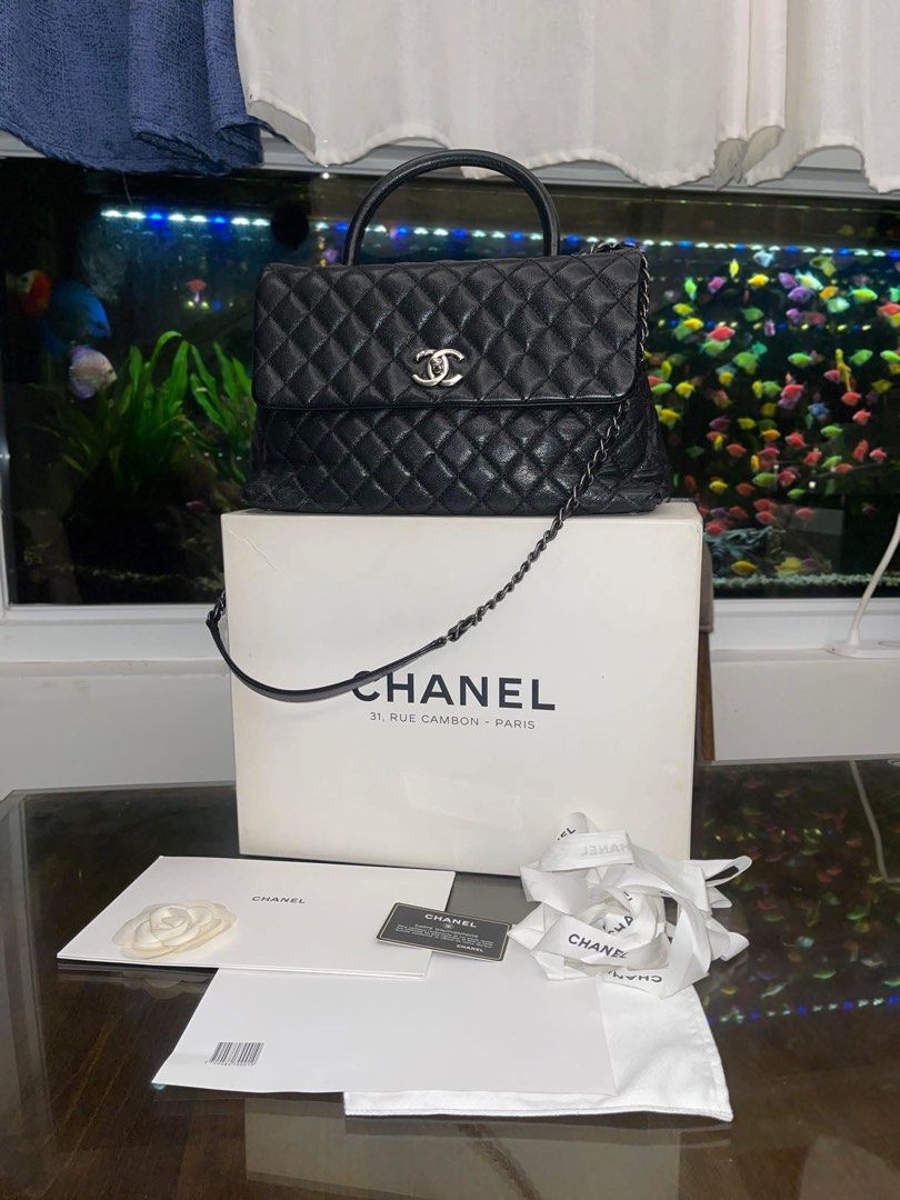 Chanel Black Caviar Coco Handle Bag (Category: Luxury Bags & Wallets) located in Davao. Submitted by makeupbynoeh (Listing ID 1455118314, Image 2). Description: - Chanel Black Caviar Large Coco Handle - Material: Black caviar leather, Series 22 - Hardware: Ruthenium (RHW) - Features: Top handle w/ undetachable chain strap - Includes: Authenticity card, dust bag, box, and ribbon - Versatile: Ideal for day or night use.