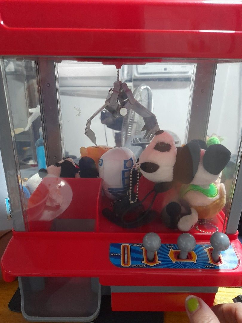 CLAW machine (Category: Interactive Toys) located in Agdangan. Submitted by csdepot (Listing ID 1388866688, Image 2). Description: Working well 12inches x 6inches (estimate) with free small stuff toys inside with token with batteries Bought from the US With FREE stuffies (4pcs) *Check images before asking pls RFS: decluttering.
