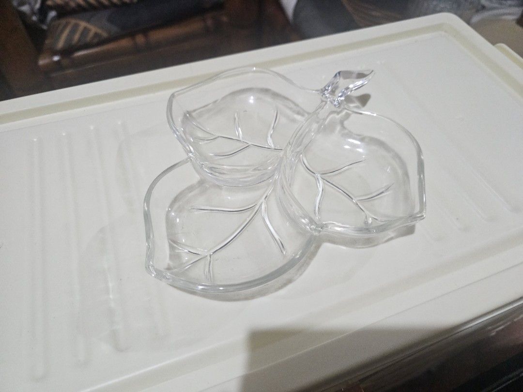 Clear Glass Leaf Shaped 3 Compartment Serving Dish (Category: Dinnerware & Cutlery) located in General Trias. Submitted by kittykate__ (Listing ID 1455069252, Image 2). Description: - Clear glass serving dish - Shaped like three leaves with a stem - Features three compartments - Ideal for serving snacks, dips, or condiments - Adds a decorative touch to your table.