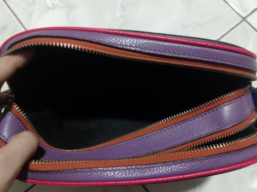 Coach Black Leather Bag with Multi-Color Trim (Category: Luxury Bags & Wallets) located in Manila. Submitted by caaths_collection (Listing ID 1455032095, Image 3). Description: - Coach black pebbled leather bag - Eye-catching multi-color trim: purple, red, and orange - Unique blue stripe detail on the front - Secure zipper closure - Spacious interior with Coach New York authenticity patch - Perfect for carrying your daily essentials - preloved - 