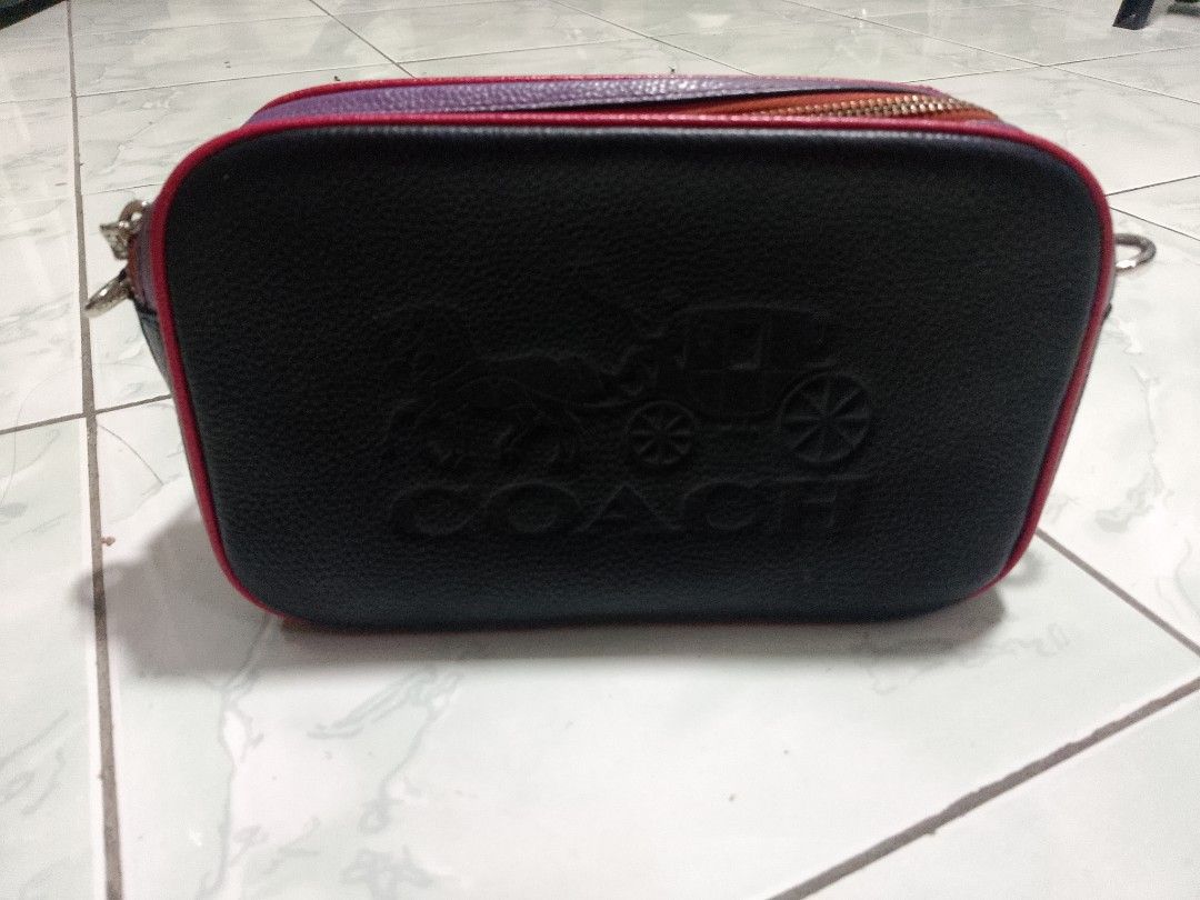 Coach Black Leather Bag with Multi-Color Trim (Category: Luxury Bags & Wallets) located in Manila. Submitted by caaths_collection (Listing ID 1455032095, Image 1). Description: - Coach black pebbled leather bag - Eye-catching multi-color trim: purple, red, and orange - Unique blue stripe detail on the front - Secure zipper closure - Spacious interior with Coach New York authenticity patch - Perfect for carrying your daily essentials - preloved - 