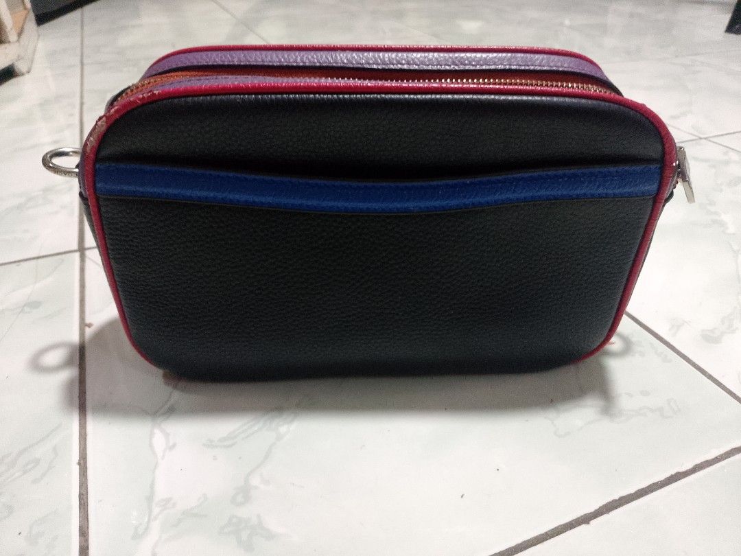 Coach Black Leather Bag with Multi-Color Trim (Category: Luxury Bags & Wallets) located in Manila. Submitted by caaths_collection (Listing ID 1455032095, Image 2). Description: - Coach black pebbled leather bag - Eye-catching multi-color trim: purple, red, and orange - Unique blue stripe detail on the front - Secure zipper closure - Spacious interior with Coach New York authenticity patch - Perfect for carrying your daily essentials - preloved - 