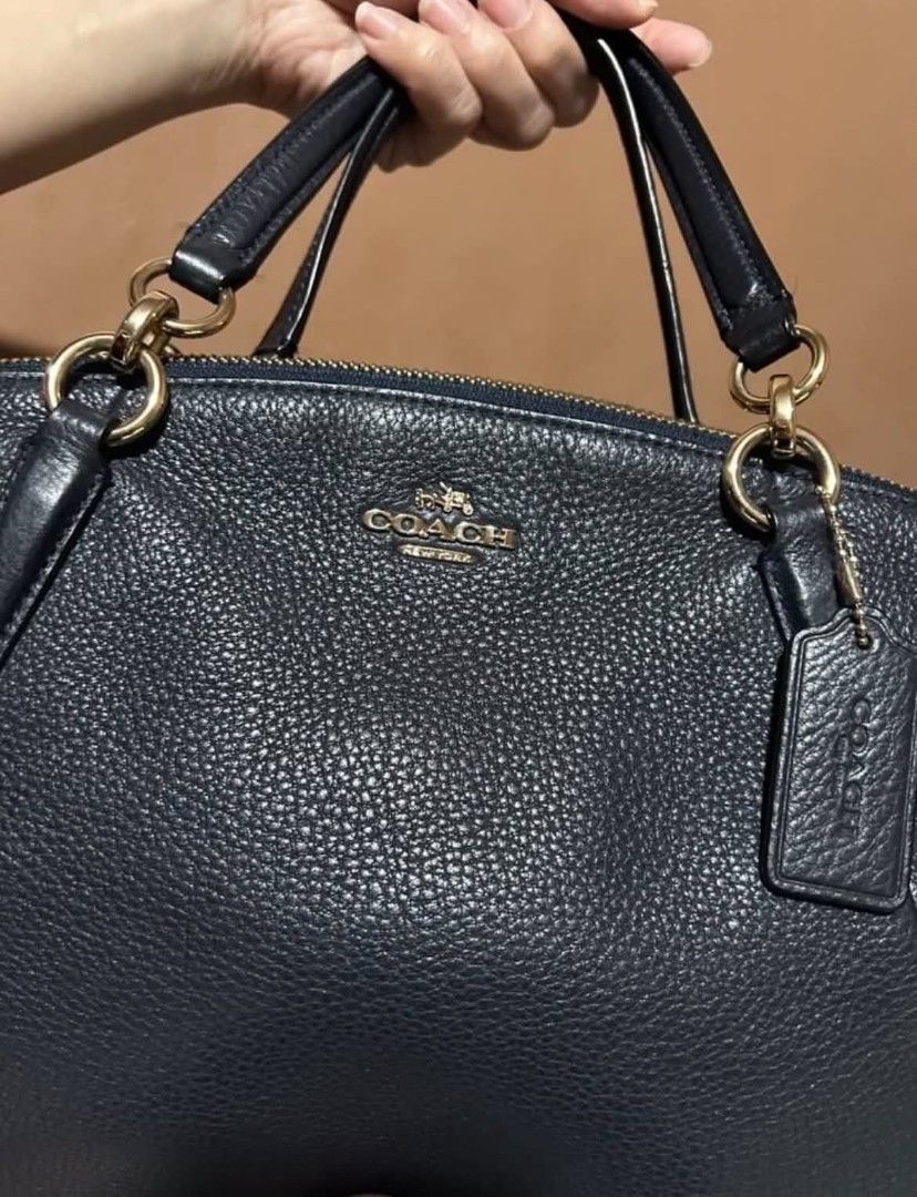 Coach Pebble Leather Satchel Handbag (Category: Luxury Bags & Wallets) located in Las Pinas. Submitted by luxeprelovedstuff (Listing ID 1455005422, Image 2). Description: -still like new - Navy blue Coach satchel - Genuine pebble leather with gold hardware - Secure top zip closure - Interior zip and slip pockets for organization - Includes a detachable crossbody strap for versatile wear - Ideal everyday bag with origibal dustbag.