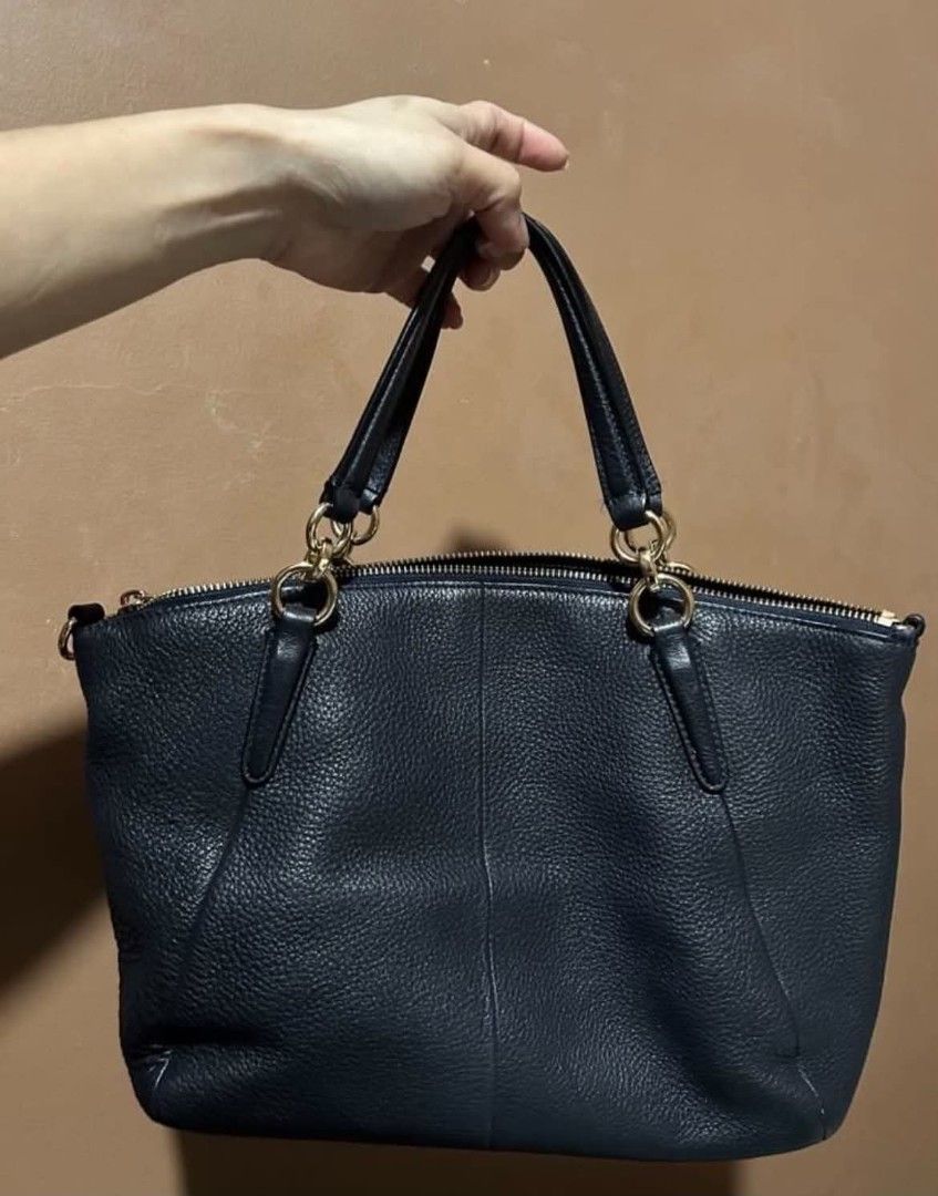 Coach Pebble Leather Satchel Handbag (Category: Luxury Bags & Wallets) located in Las Pinas. Submitted by luxeprelovedstuff (Listing ID 1455005422, Image 3). Description: -still like new - Navy blue Coach satchel - Genuine pebble leather with gold hardware - Secure top zip closure - Interior zip and slip pockets for organization - Includes a detachable crossbody strap for versatile wear - Ideal everyday bag with origibal dustbag.