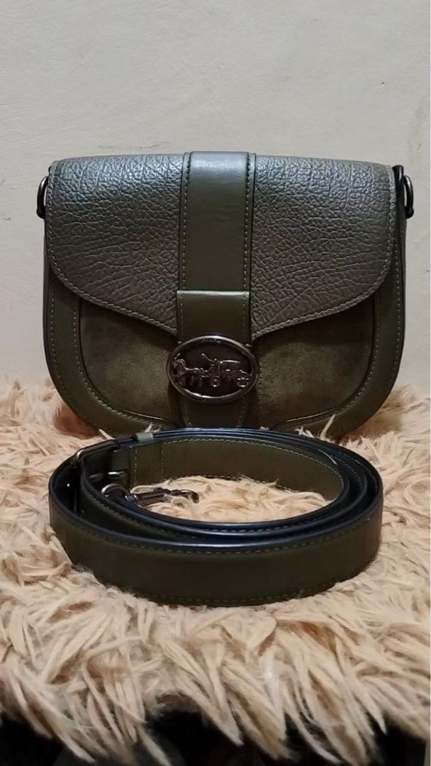 Coach Saddle Bag Olive Green Leather Suede (Category: Luxury Bags & Wallets) located in Quezon City. Submitted by _rinyang (Listing ID 1455015759, Image 1). Description: - Olive green Coach saddle bag - Textured leather with suede front flap accents - Silver horse and carriage logo hardware - Detachable crossbody strap included - Ideal size for everyday essentials - Clean interior - Ready for a new owner.