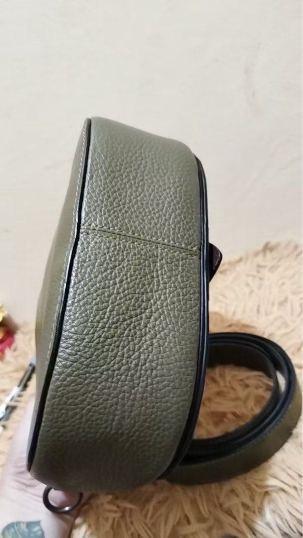 Coach Saddle Bag Olive Green Leather Suede (Category: Luxury Bags & Wallets) located in Quezon City. Submitted by _rinyang (Listing ID 1455015759, Image 2). Description: - Olive green Coach saddle bag - Textured leather with suede front flap accents - Silver horse and carriage logo hardware - Detachable crossbody strap included - Ideal size for everyday essentials - Clean interior - Ready for a new owner.
