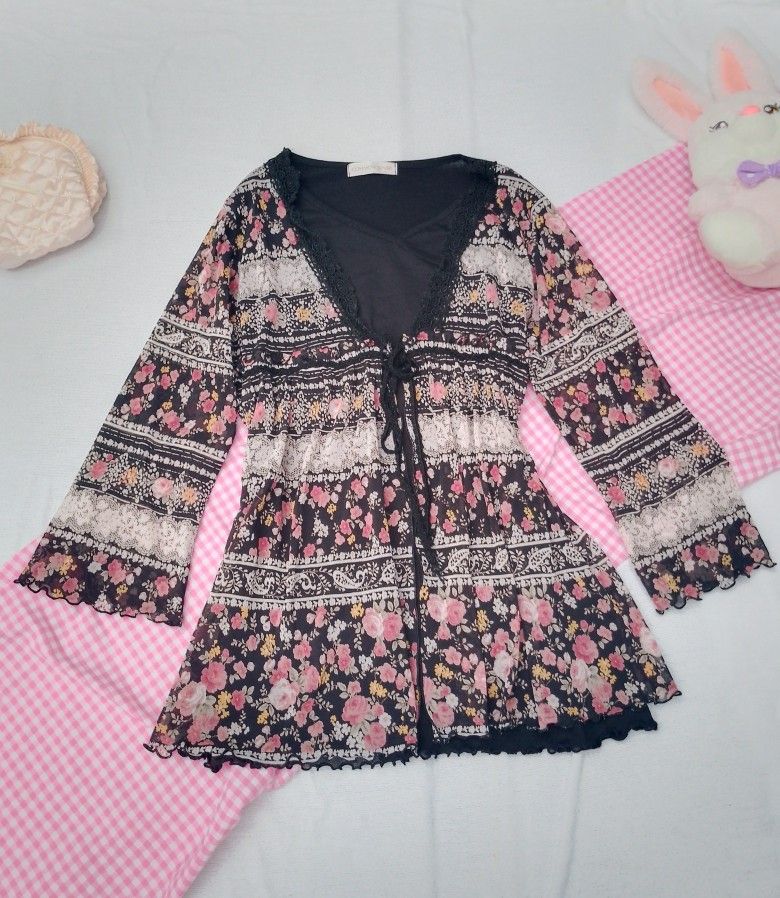 Common Sense Floral Sheer Long Sleeve (Category: Coats, Jackets and Outerwear) located in Laur. Submitted by zystilo (Listing ID 1455050000, Image 1). Description: - s-m - Sheer floral print cardigan from Common Sense - Features black lace trim - Tie front closure - Long bell sleeves - Ideal for boho or vintage looks - Adds a pop of color to any outfit.