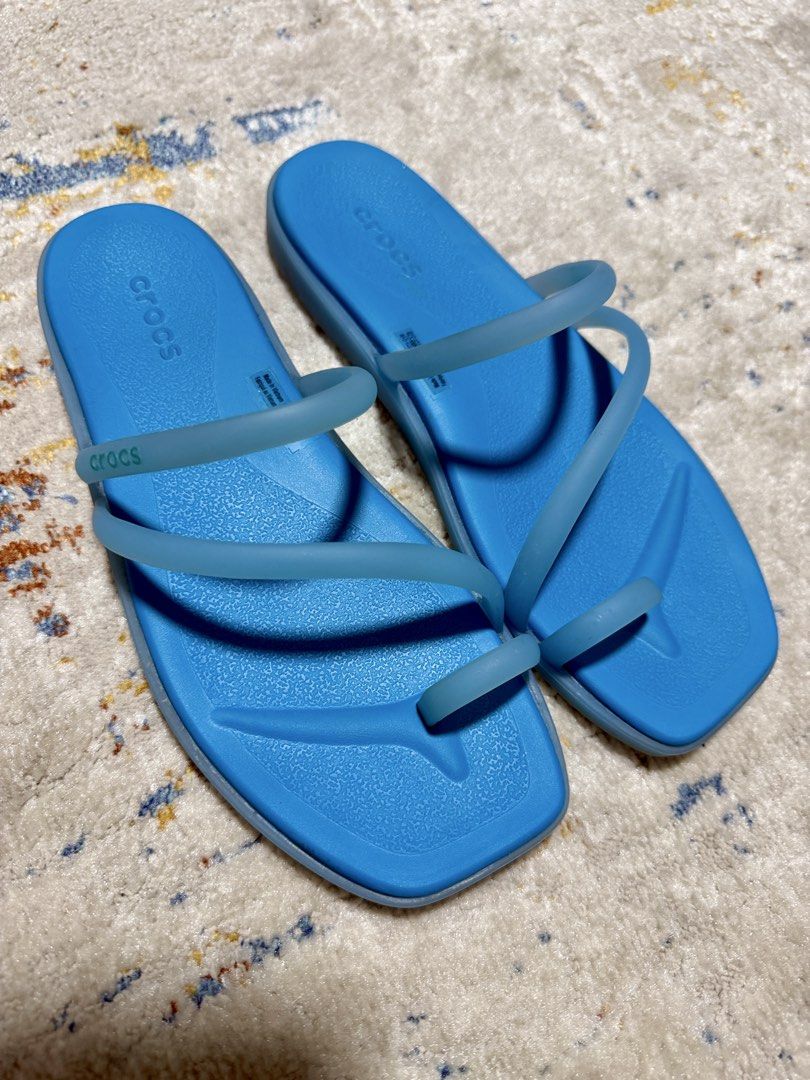 Crocs Blue Toe Loop Slide Sandals Women's Size 6 (Category: Flats & Sandals) located in Manila. Submitted by savershopph (Listing ID 1455087380, Image 2). Description: - Blue Crocs slide sandals - Toe loop design with thin straps - Comfortable and easy to wear - Ideal for casual outings - Features classic Crocs tread pattern on soles.