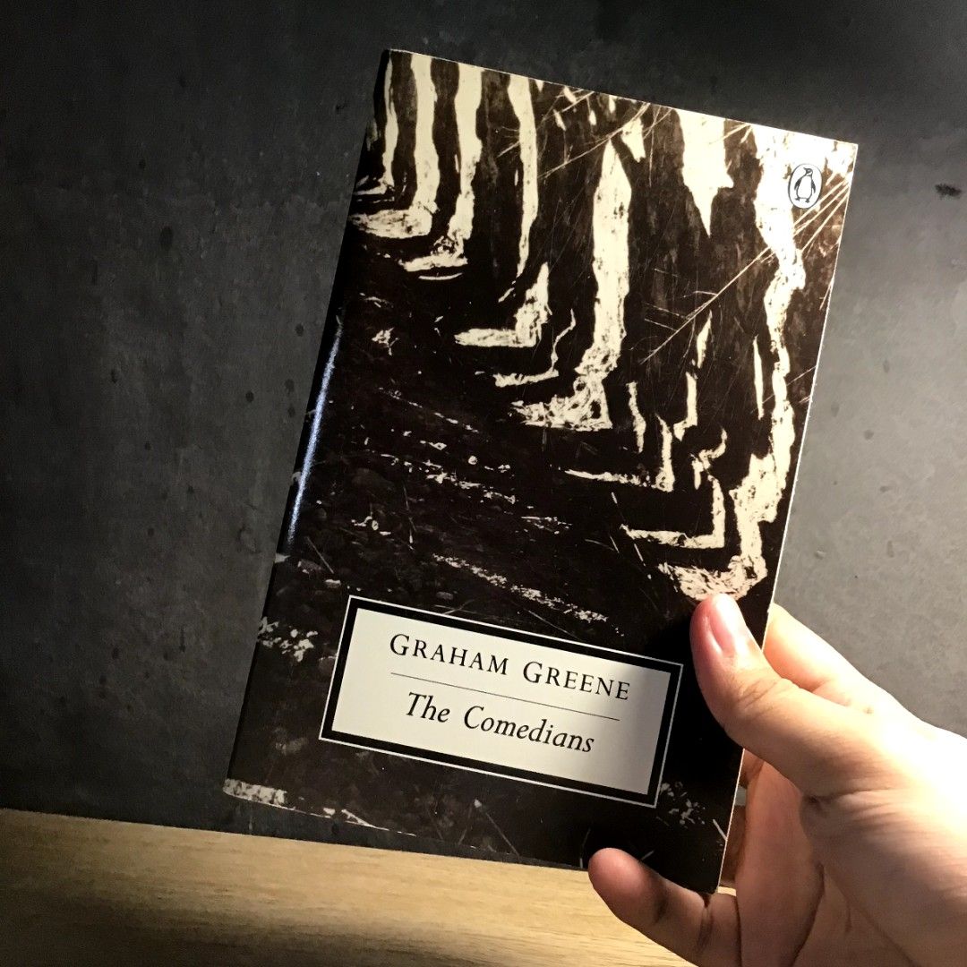 Graham Greene The Comedians (Category: Storybooks) located in Caloocan City. Submitted by animobooks (Listing ID 1426106350, Image 3). Description: Copy of Graham Greene's novel, The Comedians. Published by Penguin Books. The back cover features quotes and a brief synopsis. The book's cover art depicts a black and white image. The price tag shows $14.99. * Normal size Paperback * Penguin Modern Classics * AUTHENTIC BOOK - This is a preloved book.