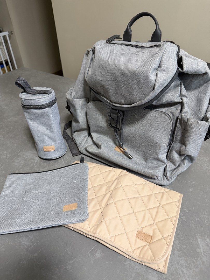 Grey Diaper Backpack with Changing Mat, Bottle Holder & Pouch (Category: Diaper Bags & Wetbags) located in Taytay. Submitted by thestyletwins (Listing ID 1455065991, Image 1). Description: - Grey diaper backpack set - Includes changing mat, bottle holder, and small pouch - Multiple pockets for excellent organization - Zippers in good working condition - Adjustable straps for comfort - Perfect for parents on the go.