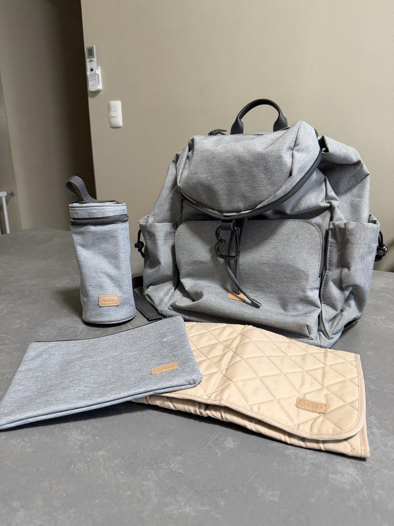Grey Diaper Backpack with Changing Mat, Bottle Holder & Pouch (Category: Diaper Bags & Wetbags) located in Taytay. Submitted by thestyletwins (Listing ID 1455065991, Image 2). Description: - Grey diaper backpack set - Includes changing mat, bottle holder, and small pouch - Multiple pockets for excellent organization - Zippers in good working condition - Adjustable straps for comfort - Perfect for parents on the go.