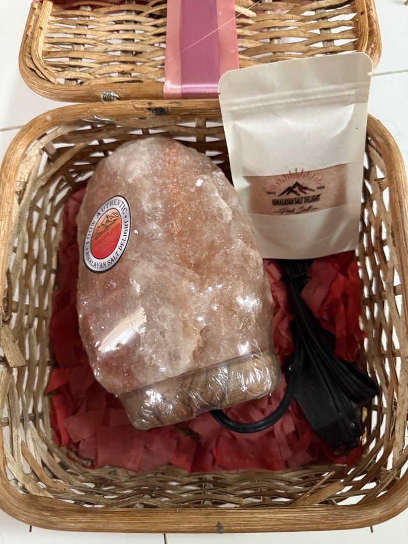 Himalayan Salt Lamp & Pink Salt Gift Basket (Category: Lighting) located in Paranaque City. Submitted by bratty.20 (Listing ID 1454953790, Image 1). Description: - Beautifully presented gift basket - Includes a large Himalayan salt lamp (still in original plastic wrap) - Comes with a small pouch of Himalayan pink salt - Decorated with charming pink ribbons and dried flowers - Makes a perfect gift or a lovely addition to your home decor.